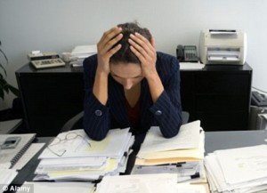 Back Pain with Women Woman at a desk looking at files